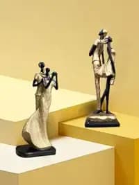 golden black resin romantic couple statues